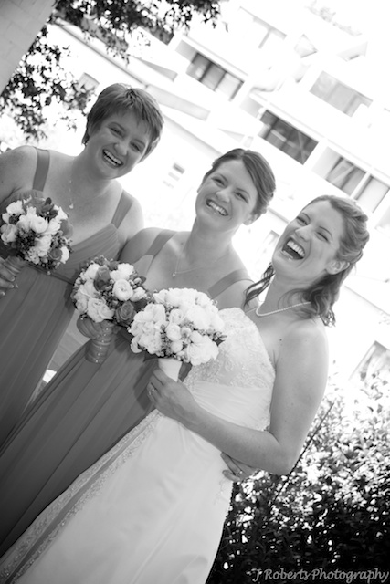 Bride laughing with bridesmaids wedding photography